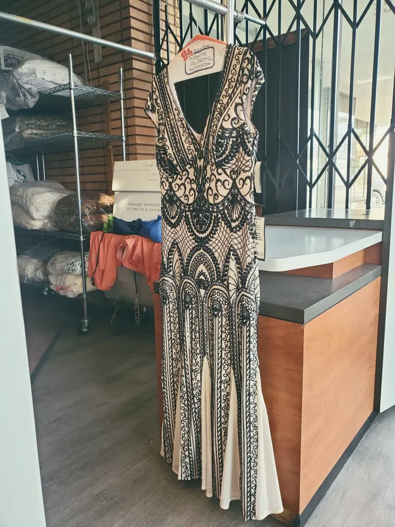 A beaded gown hanging by the counter